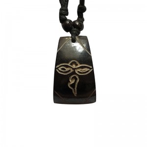 Buddha eye carved bone pendent.