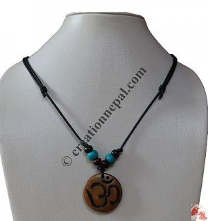 Om carved bone pendant